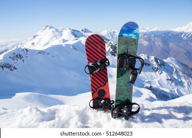 
Two snowboard standing in the snow against the backdrop of the beautiful snow-capped mountains