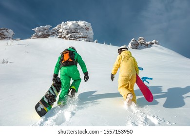 Two Snowboarders Walking Uphill. Backcountry Skiing And Snowboarding Concept At Ski Resort