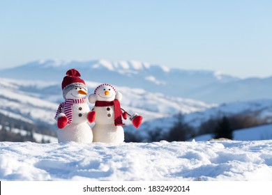 Two snowmen in the winter mountains - Powered by Shutterstock