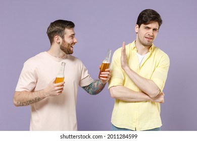 Two Sober Young Men Friends Together 20s Wearing Casual T-shirt Tattoo Translate Fun Refusing Do Stop Palm Gesture Drink Beer Isolated On Purple Background Studio Portrait People Lifestyle Concept.