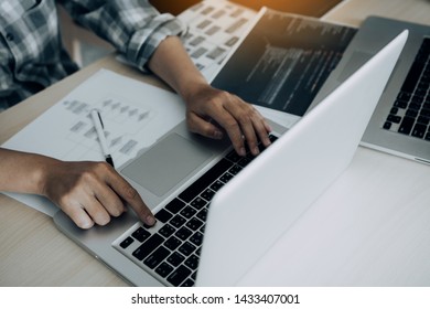 Two software developers are analyzing together about the code written into the program on the computer.