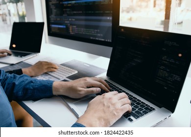 Two software developers are analyzing together about the code written into the program on the computer.