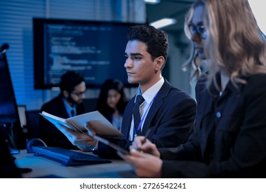 Two software developers smile with satisfaction during a pair programming session, as one points to a successfully executed block of code after solving a complex programming problem.