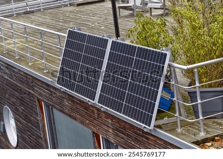 Two solar modules Solar panels are installed as a balcony power plant in Germany on the railing of a roof terrace and generate electricity for the owner in order to save electricity costs