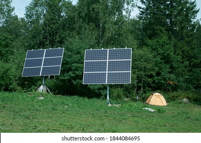 Two Solar Pannel And Tourist Tent In Fores. Renewable Energy And Ecology.