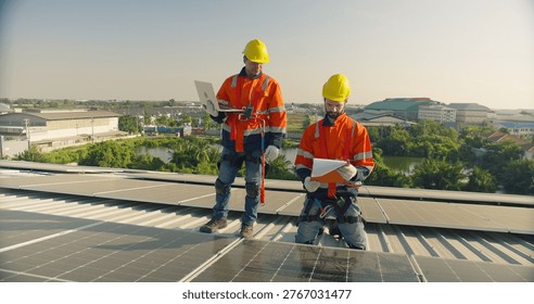 Two solar technicians inspect and analyze photovoltaic panels on a rooftop power plant, focusing on renewable energy efficiency, sustainable power generation, and expert system maintenance.