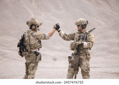 Two soldiers greeting together celebrating success - Powered by Shutterstock