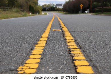 two solid yellow lines on the road