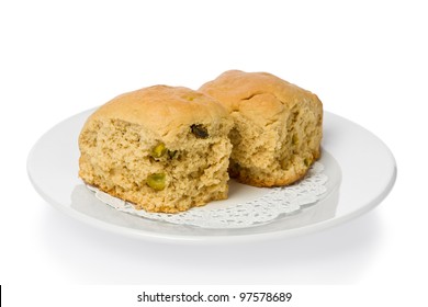 Two South African Style Buttermilk Rusks With Pistachios On A Small White Plate.