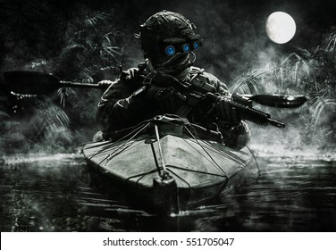 Two special forces operators with night vision goggles paddling in the army kayak in the jungle. Cloudy night, full moon, damp