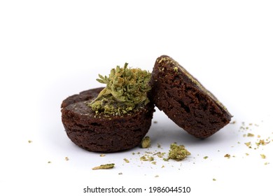 Two Special Pot Brownies With Crumbled Marijuana Isolated Over White