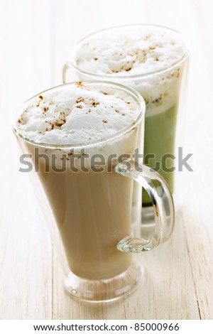 Two specialty tea latte beverages of chai and matcha teas