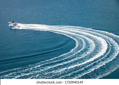 Two Speedboat Runs Fast In The Open Sea And Leaves The Engine's Wake In The Water