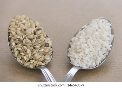 Two Spoons With Brown And White Rice