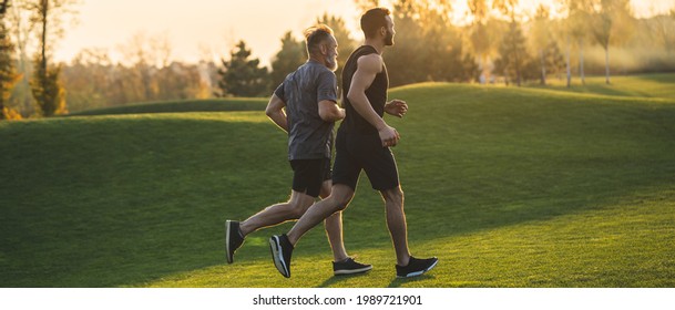 The two sportsmen running on the grass in the park