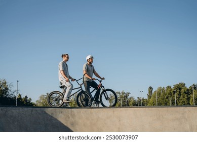 Two sporty riders upgrading skills at outdoors skateboarding park in residential area - Powered by Shutterstock