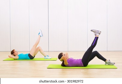 Two sporty young girls at fitness club