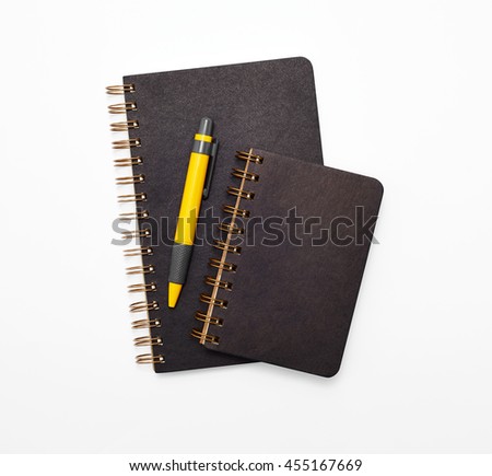 Two stack sprial binding book with pen on white background.