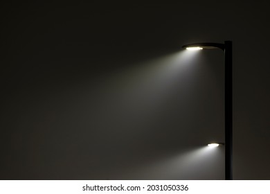 Two Stacked Parking Lot Lights Shining Through Wildfire Smoke At Night Time