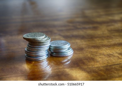 Two stacks of coins of different values on the table - Shutterstock ID 510665917