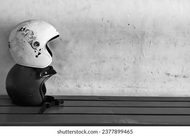 Two stacks of helmets on a table with a black and white concept
