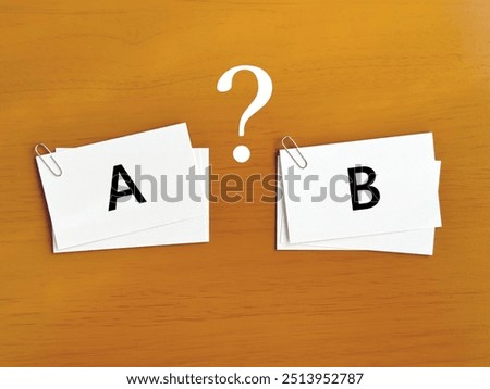 Two stacks of notes with the letters A and B attached with paper clips