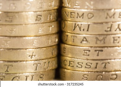 Two stacks of UK pound coins forming a background