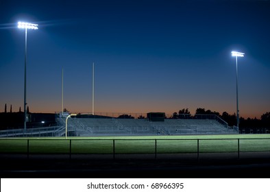 Two Stadium Lights Sparkle In The Night