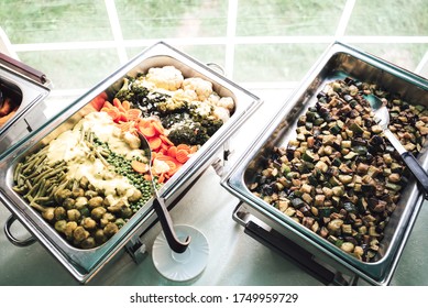 Two Stainless Hotel Pans On Food Warmers. Warm Vegetable As Side Dishes. Self-service Buffet Table. Celebration, Party, Birthday Or Wedding Concept.