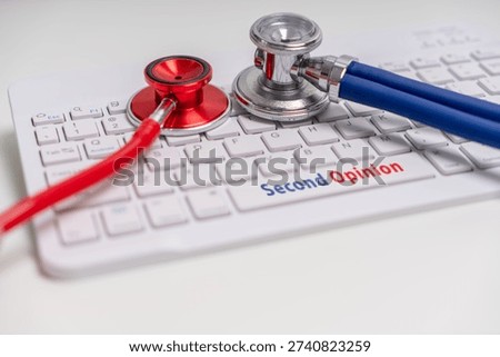 Two Stethoscopes on keyboard with second opinion text, healthcare advice and review concept.