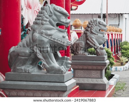 Two Stone lion sculpture in front of a monastery