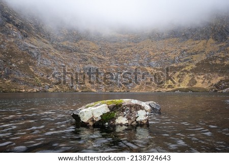 Two stones in Paddler's lake in Conor's pass. 