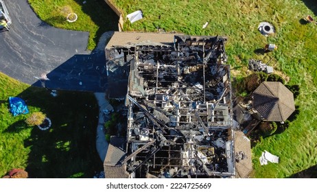 Two story residential house with round gazebo in backyard damaged by fire in Rochester, New York, USA. Large two story home totally damaged by fire disaster, insurance claim background