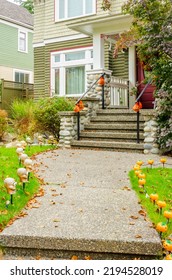 Two Story Stucco Luxury House With Garage Door, Big Tree And Nice Fall Foliage Landscape In Vancouver, Canada