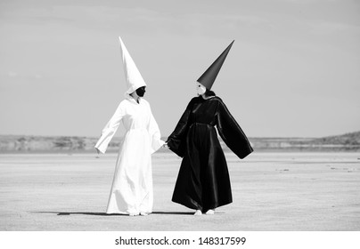 Two Strange People In Black Cloak And White Cloak Talking. Artwork