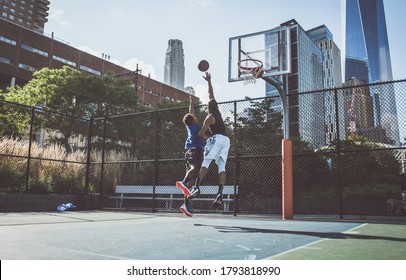 Two street basketball players playing hard on the court - Powered by Shutterstock