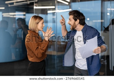 Two stressed colleagues arguing and expressing anger in a heated discussion, confronting each other during a toxic work environment and professional challenge