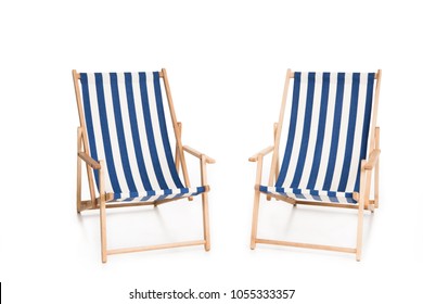 two striped beach chairs, isolated on white