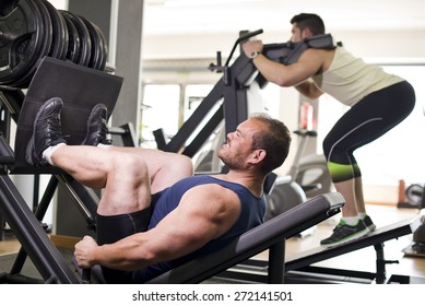 Two Strong Men At Gym Traning Legs With Press.