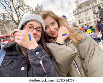 Two Student Girls With Flag Of Ukraine Painted On Their Hands. People At Protest Meeting In Support Of Ukraine, No War, Stop War, European Solidarity Against Russian Aggression. 03.06.2022. London. UK