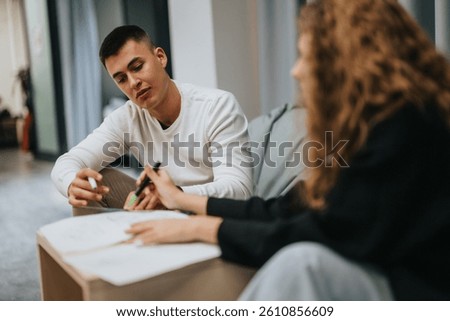 Two students engage in a focused study session, discussing academic material and collaborating on assignments in a school setting.
