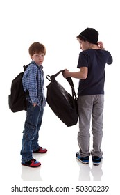two students seen with his back to the school bags, one looking back, isolated on white background