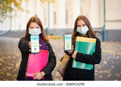 Two students showing screens of their phones with electronic variant of their vaccination certificate. Vaccination of students