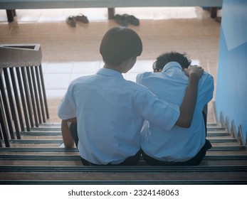 Two students sit down and hug to support a depressed man - a man supports his friend in despair for his love problems. The concept of best friends