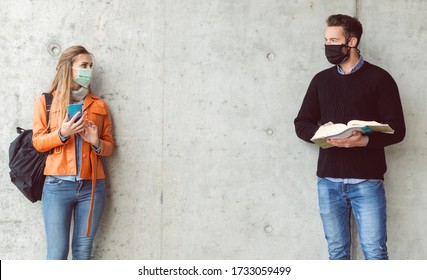Two Students Standing In Social Distance Wearing Face Mask Looking At Each Other