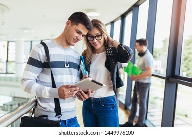 Two students using they digital tablet in a university.