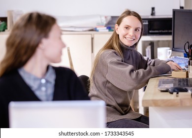 Two Successful Beautiful Caucasian Positive Young Women Employees Of A Large Company Discuss Strategy Of Development Of Small Business. Concept Of Friendly Team And Effective Work In Office