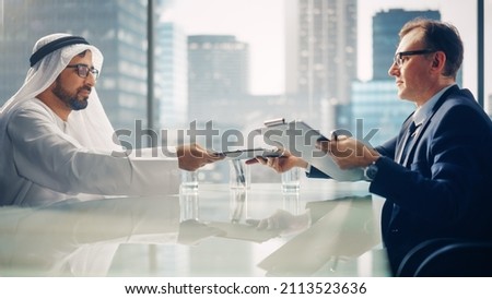 Two Successful Multicultural Businessmen Sitting in Office and Signing Contract. Arab Business Partner with Investor  Make Lucrative Financial Deal. Saudi, Emirati, Arab Businessman Concept.