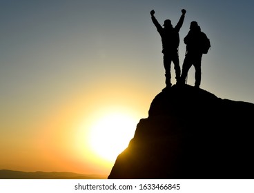 two successful people observe the environment from the summit and enjoy amazing views - Shutterstock ID 1633466845