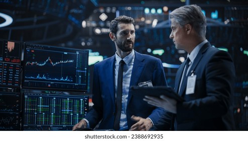 Two Successful Traders Analyzing Real-Time Financial Data and Reports About the State of the Finance Market. Stock Exchange Professionals Discussing Buy and Sell Options For Different Bonds - Powered by Shutterstock - Get 15% off with code: PIKWIZARD15